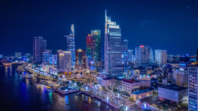 Aerial night illuminated Saigon city skyline skyscrapers view and busy traffic on the main road of Ho Chi Minh