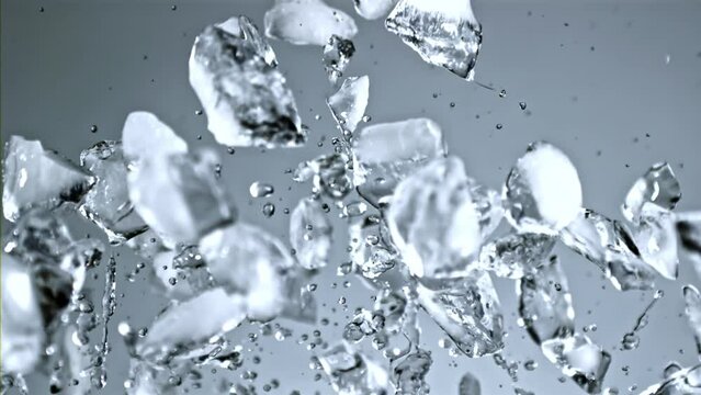Super slow motion pieces of ice rise up and fall down. High quality FullHD footage