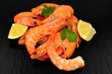 Group of freshly cooked shell on crevettes with lemon and parsley herb garnish