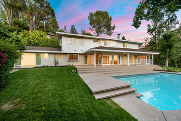 Spacious backyard with pool and grassy area at renovated Los Angeles residence