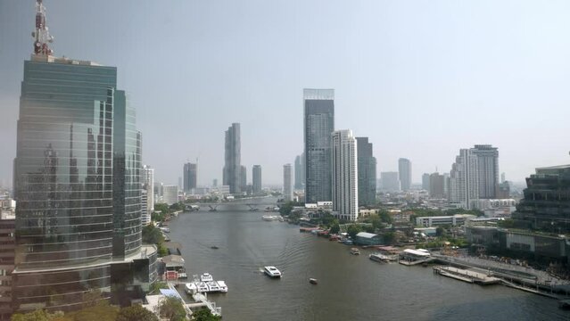 view of Chaophraya River with skyscraper in the city of bangkok in daytime