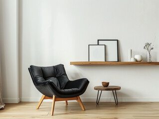 Black armchair with wooden furniture in white walled room and wooden floor in daylight.