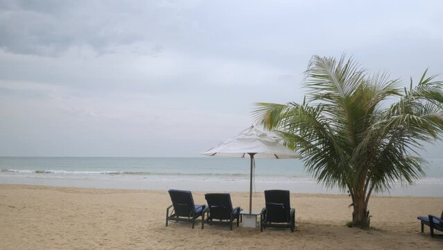 Luxury beach lounge beds with umbrella on white sand beach