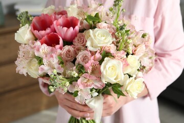 Woman with beautiful bouquet of fresh flowers indoors, closeup