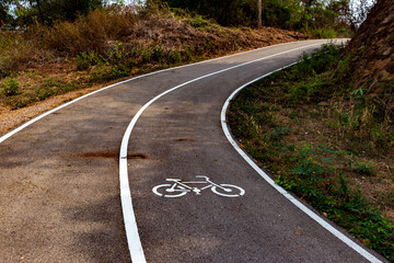 Bicycle lane on the asphalt road in the forest mountain.