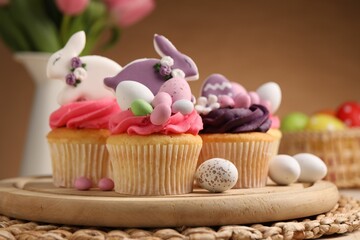 Tasty cupcakes with Easter decor on table