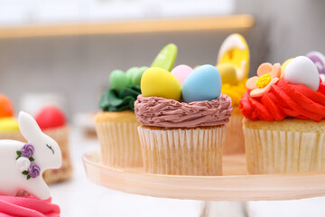 Tasty decorated Easter cupcakes on table, closeup