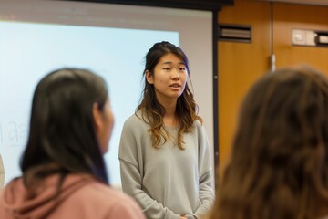 Female student presenting in front of classroom
