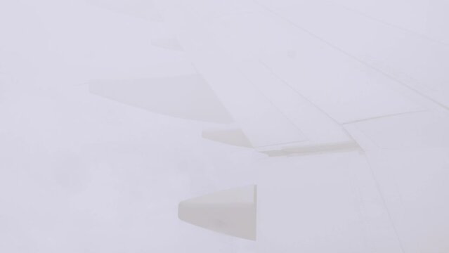 view from inside cabin of airplane aircraft while flying in sky passing through the cloud mist, transportation natural