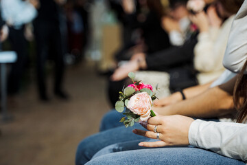 A woman is holding a beautiful bouquet of flowers at a formal event
