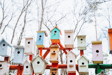 Stacked colorful bird houses create a vibrant urban design in the sky