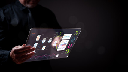 A database manager is holding a tablet with a screen that shows a graph. Concept of technology and data analysis - obrazy, fototapety, plakaty