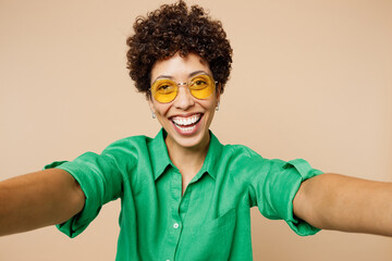 Close up young woman of African American ethnicity wear green shirt casual clothes glasses doing...