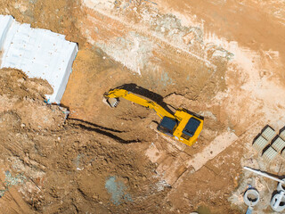 Excavator on earthmoving at construction site, aerial view. - 781906742