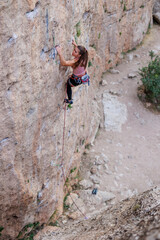 Obraz premium sport climbing. the girl overcomes the climbing route on the rock.