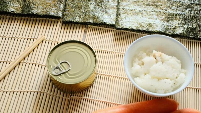 canned tuna, rice, vegetables and sushi seaweed.
Sushi preparation ingredients
