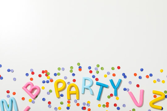 The word "party" from colored plasticine on a white background.