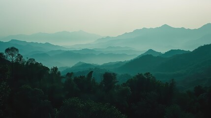Fototapeta premium Serene Dawn Mist Over Layered Mountain Range