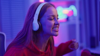 Caucasian e-sport woman gamer playing online video game on computer. 