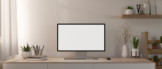 A contemporary minimalist home office features a computer mockup and decor on a minimal wood table.