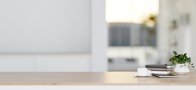 A close-up image of a wooden tabletop for display products in a minimalist white room.
