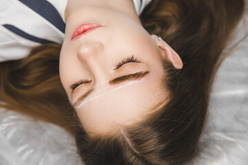 A cosmetologist applies permanent makeup to the eyebrows - eyebrow tattoo. eyebrow perm