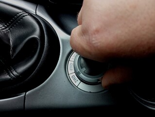 A human hand switches the off-road mode of the car with a switch. Connecting the distribution of...