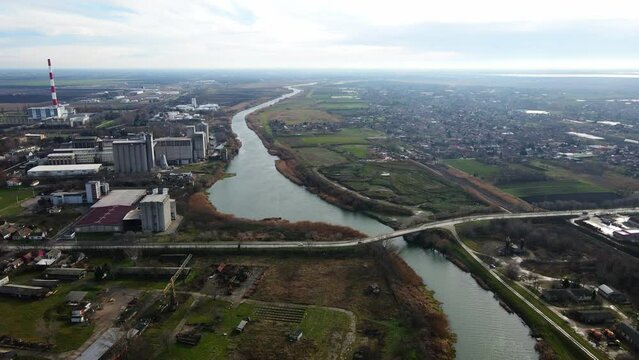 Aerial footage of a bridge over Bega river in industrial district of Zrenjanin