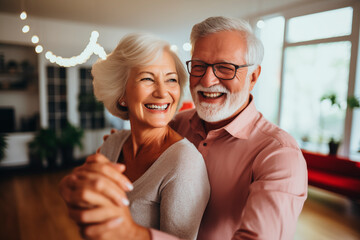 An elderly couple joyfully dancing in a well-lit room, both smiling broadly, highlighting a moment of happiness and connection.