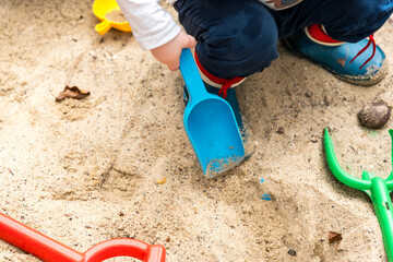 Colorful children's toys in a sandpit