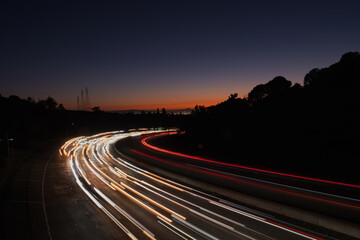 View of light streaks created by traffic coming from San Francisco and Oakland at sunset, as seen...