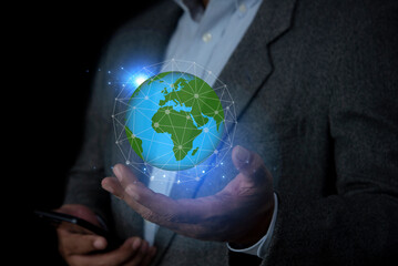 Businessman holding the world in the palm of hands concept for global business, communications, politics or environmental conservation