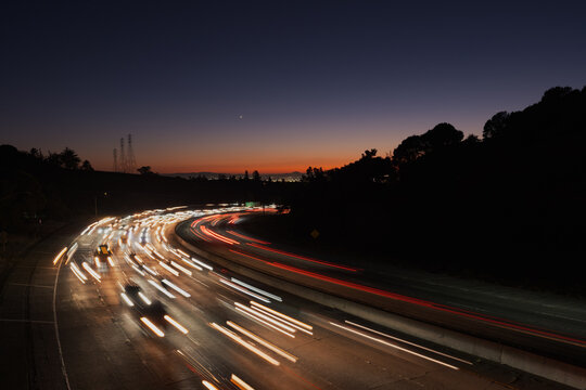 Countless cars stream along Highway 24 in Oakland at sunset, heading inland from San Francisco and the rest of the Bay Area.