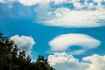 Clouds in the blue sky on a sunny daybe used as background. unusual clouds