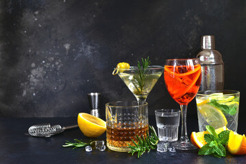 Set of alcoholic drinks (vodka, whiskey, aperol spritz, martini, lemon mojito ) on the bar counter. - obrazy, fototapety, plakaty