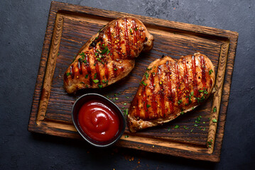 Grilled spicy chicken breasts. Top view with copy space. - 781940372