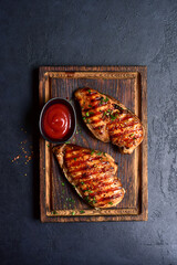 Grilled spicy chicken breasts. Top view with copy space. - 781940374