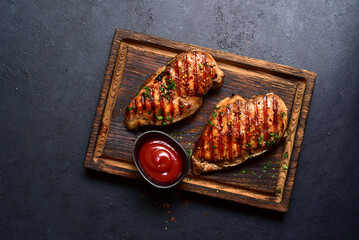 Grilled spicy chicken breasts. Top view with copy space. - 781940572