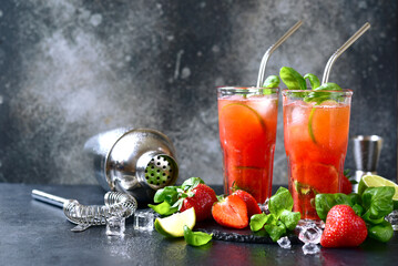 Cold summer strawberry cocktail with lime and basil in a  glasses . - 781942154