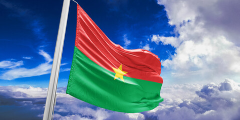Burkina Faso national flag cloth fabric waving on beautiful Blue Sky Background. - obrazy, fototapety, plakaty