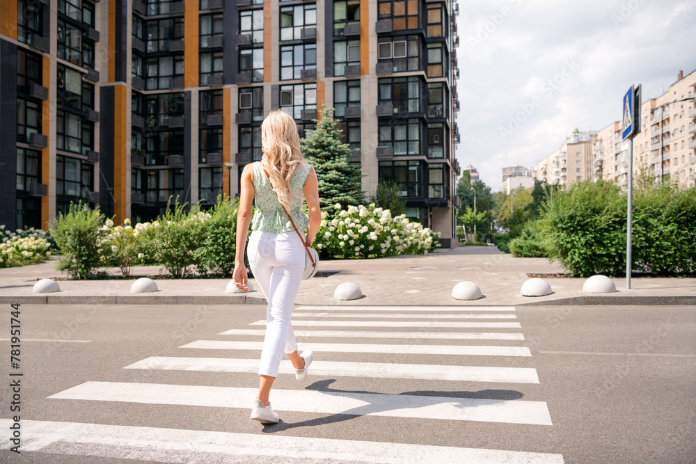 Wall mural rear view photo of nice adorable stunning stylish girl walking going home modern apartment city stre