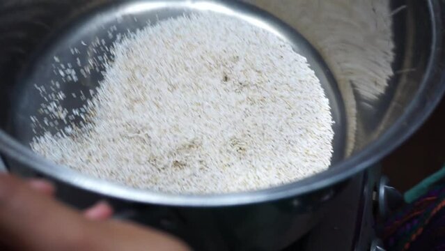 Closeup of popping amaranth seeds in a metal pot