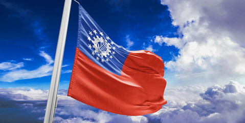 Myanmar (Burma) national flag cloth fabric waving on beautiful Blue Sky Background.