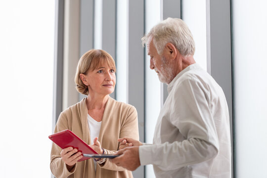 Senior Couple Having An Argument, Serious Women And Man Talking About Works