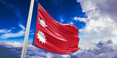 Nepal national flag cloth fabric waving on beautiful Blue Sky Background.