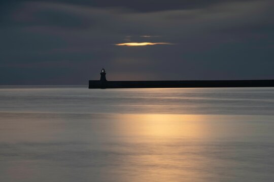 Tranquil view of the South Shields pier and lighthouse at sunrise in Tynemouth, England