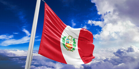 Peru national flag cloth fabric waving on beautiful Blue Sky Background.