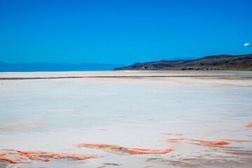 Scenic view of Lake Urmia in Iran under a cloudless blue sky on a sunny day - obrazy, fototapety, plakaty