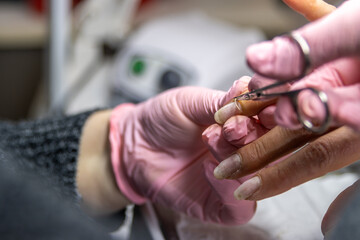 Naklejka premium Manicurist performing detailed cuticle work on client