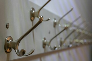 Closeup shot of a row of metal hooks for hanging coats